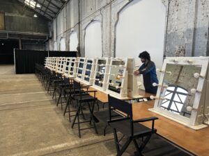 Make up Mirrors, trestle tables and director chairs being set up at carriageworks